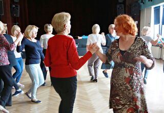 Zdjęcie: Kobiety tańczące w parach na sali z parkietem