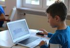 Chłopczyk tworzy grafikę na laptopie