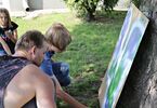 Mężczyzna i chłopiec maluje sprayem na kartonie