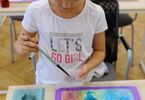 Dziewczynka nanosząca farbę na folię bąbelkową