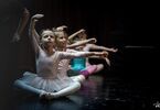 Baletnice na scenie wykonują ćwiczenie