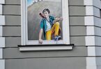 Mural z chłopcem wychodzącym przez okno