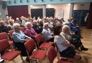 Zdjęcie seniorów siedzących na krzesłach