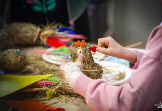 Zdjęcie: dziecięce ręce podczas formowania kury z siana