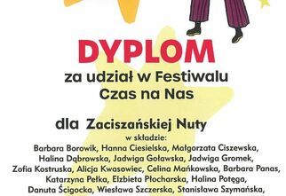 Zdjęcie dyplomu za udział dla zespołu Zaciszańska Nuta. Napisy czerwone i czarne na żółtym, po prawej stronie grafika mężczyzny